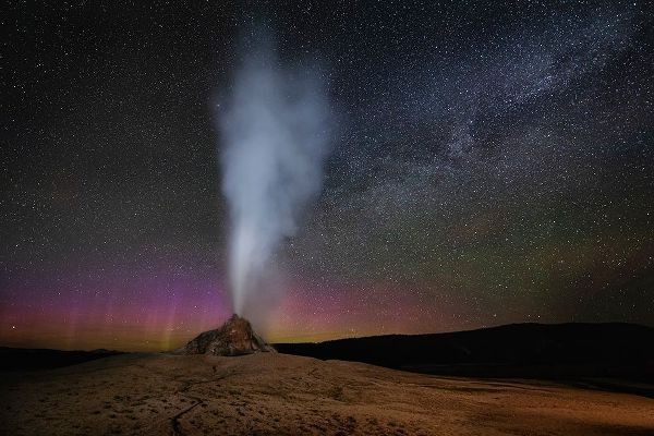 Wyoming-Yellowstone National Park Aurora and Milky Way above erupting White Dome Geyser